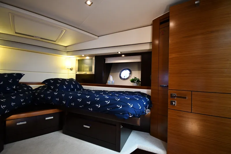 Slide: The Image of Luxurious cabin interior of 2016 Tiara Yachts 50 Coupe with nautical-themed bedding. - 25