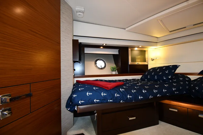 Slide: The Image of Luxurious cabin interior of 2016 Tiara Yachts 50 Coupe with nautical-themed bedding. - 26