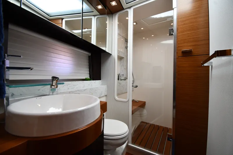 Slide: The Image of Luxurious bathroom interior of 2016 Tiara Yachts 50 Coupe with modern fixtures and wood accents. - 31