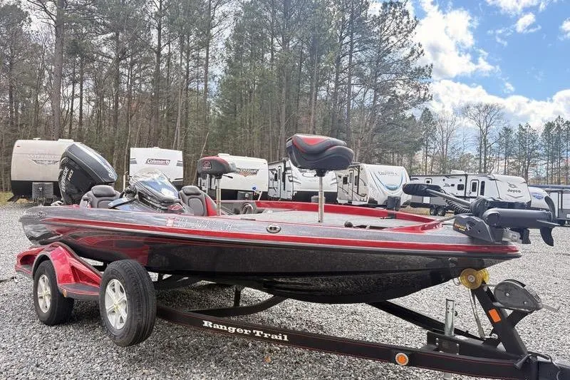 Slide: The Image of 2017 Ranger Z518 Comanche boat on trailer, parked outdoors with RVs in background. - 3