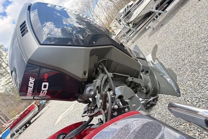 Slide: The Image of 2017 Ranger Z518 Comanche with Evinrude 150 HP outboard motor, parked on gravel. - 6