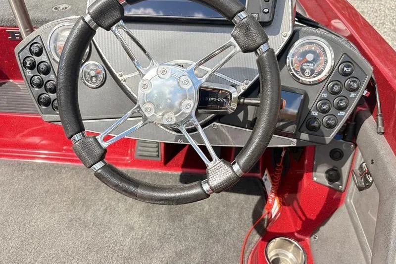 Slide: The Image of 2017 Ranger Z518 Comanche boat dashboard with steering wheel and control panel. - 7