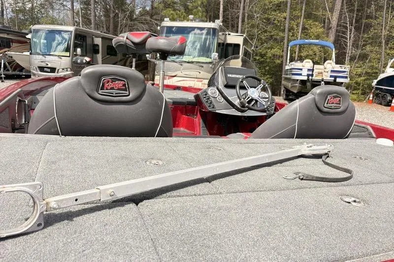 Slide: The Image of 2017 Ranger Z518 Comanche boat interior with steering wheel and seats, parked near RVs. - 8