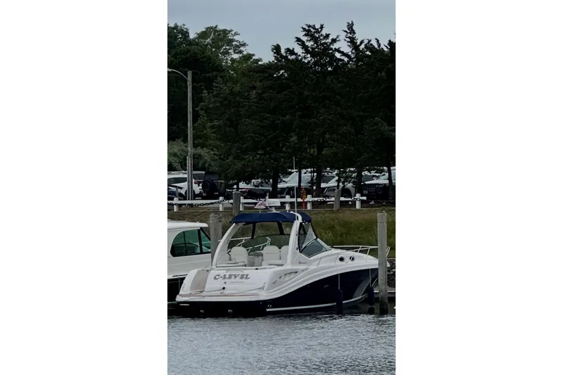 Slide: The Image of 2006 Sea Ray 340 Sundancer docked at a marina with trees in the background. - 10