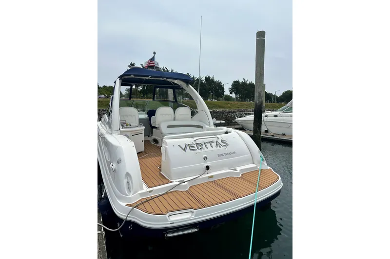 Slide: The Image of 2006 Sea Ray 340 Sundancer yacht docked, featuring spacious deck and seating. - 12