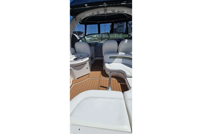 Slide: The Image of Interior of 2006 Sea Ray 340 Sundancer boat with white seating and wood flooring. - 17