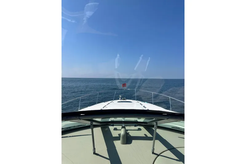 Slide: The Image of Bow view of 2006 Sea Ray 340 Sundancer cruising on open sea under clear blue sky. - 18