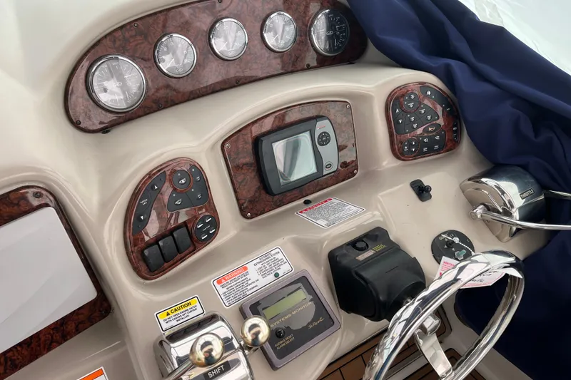 Slide: The Image of Dashboard of a 2006 Sea Ray 340 Sundancer boat with gauges and controls. - 25