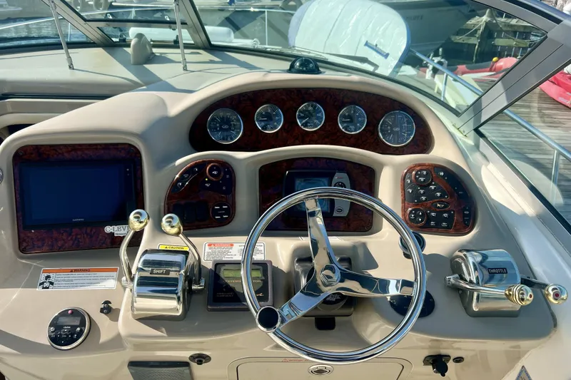 Slide: The Image of Dashboard of a 2006 Sea Ray 340 Sundancer boat with steering wheel and controls. - 26