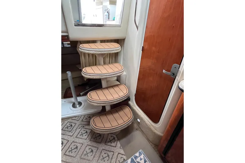 Slide: The Image of Interior stairs of 2006 Sea Ray 340 Sundancer yacht with wooden door. - 30