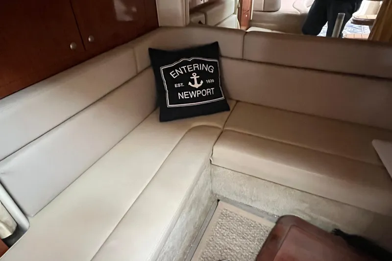 Slide: The Image of Interior of 2006 Sea Ray 340 Sundancer with beige seating and Newport-themed pillow. - 37