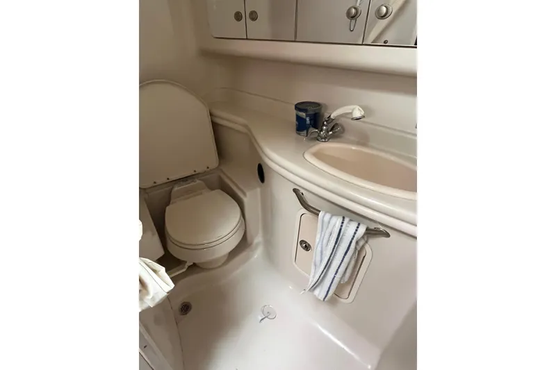 Slide: The Image of Compact bathroom in 2006 Sea Ray 340 Sundancer yacht, featuring toilet and sink. - 38