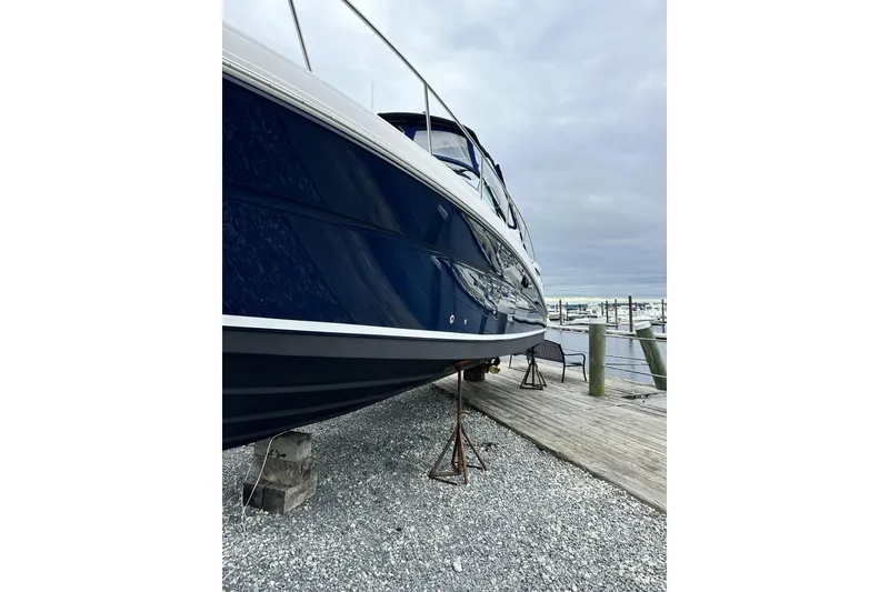 Slide: The Image of 2006 Sea Ray 340 Sundancer yacht on dry dock, marina background. - 7