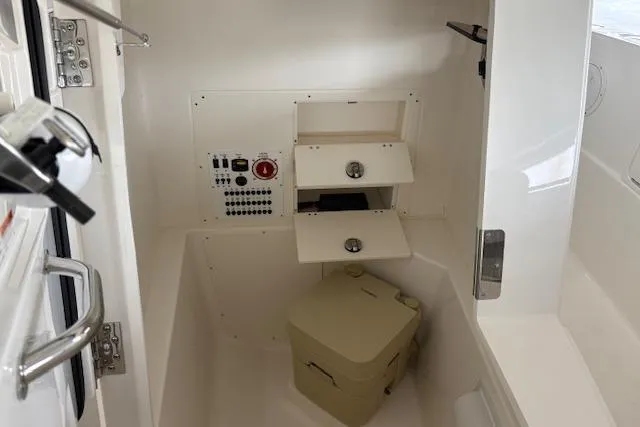 Slide: The Image of Interior of 2026 Pursuit S 248 Sport boat with control panel and storage. - 11