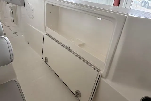 Slide: The Image of 2026 Pursuit S 248 Sport boat interior storage compartment, showcasing sleek design and functionality. - 12