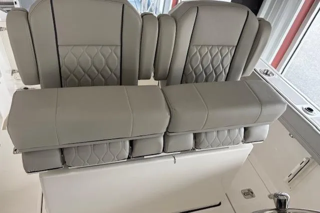 Slide: The Image of Luxury seating on 2026 Pursuit S 248 Sport boat, featuring gray upholstery and diamond stitching. - 15