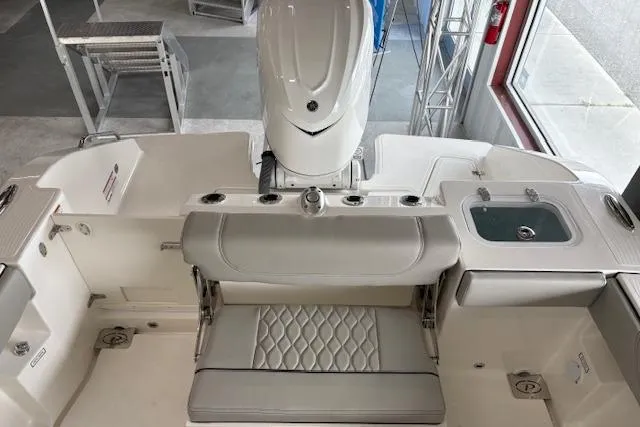 Slide: The Image of 2026 Pursuit S 248 Sport boat interior with seating and motor, showcasing luxury design. - 16