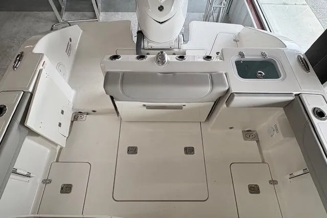 Slide: The Image of 2026 Pursuit S 248 Sport boat deck with storage compartments and seating area. - 17