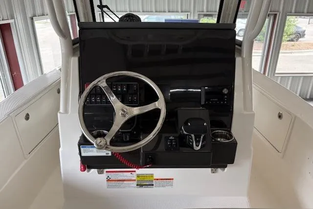 Slide: The Image of Helm of 2026 Pursuit S 248 Sport boat with steering wheel and controls. - 3