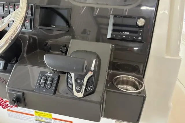 Slide: The Image of Control panel of 2026 Pursuit S 248 Sport boat with steering and electronic controls. - 4