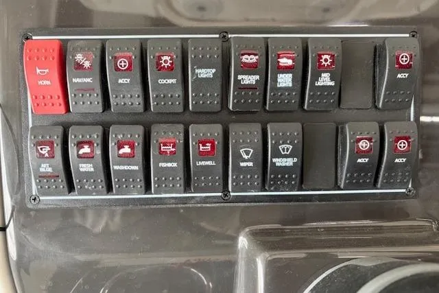 Slide: The Image of Control panel of 2026 Pursuit S 248 Sport boat with labeled switches. - 5