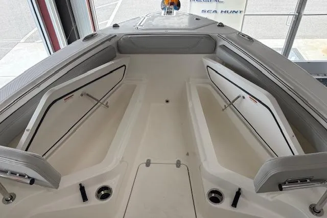 Slide: The Image of 2026 Pursuit S 248 Sport boat interior with open storage compartments. - 8