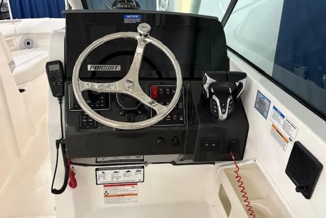 Slide: The Image of Steering console of 2026 Pursuit DC 266 Dual Console boat with controls and gauges. - 10