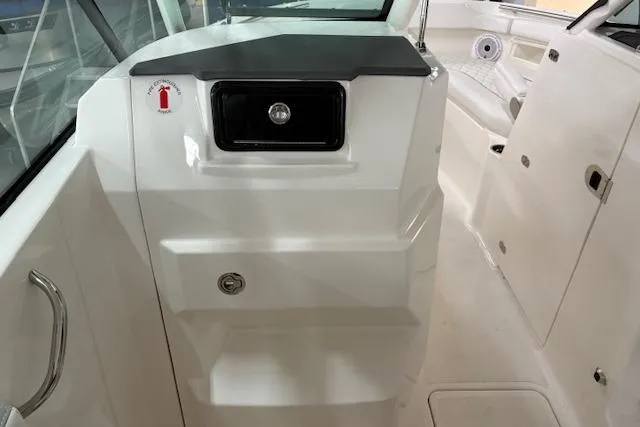 Slide: The Image of 2026 Pursuit DC 266 Dual Console interior with storage compartments and sleek design. - 11