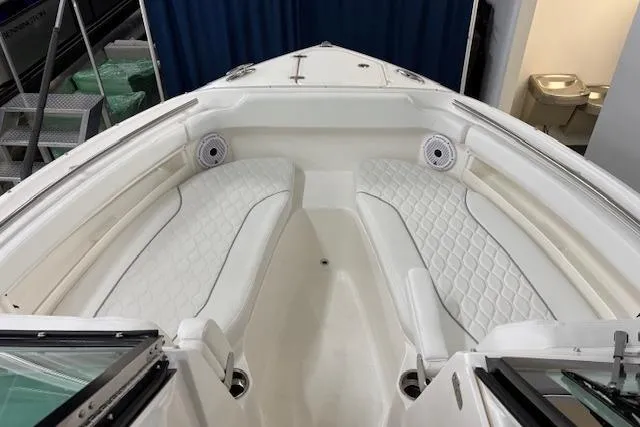 Slide: The Image of 2026 Pursuit DC 266 Dual Console boat interior with white cushioned seating. - 15