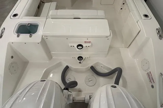 Slide: The Image of 2026 Pursuit DC 266 Dual Console boat interior with dual engines and storage compartments. - 3