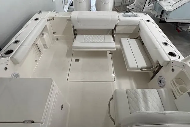 Slide: The Image of 2026 Pursuit DC 266 Dual Console boat interior with white seating and spacious layout. - 4