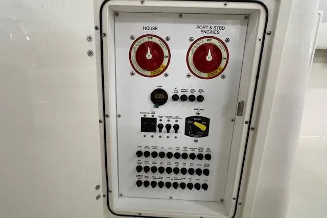 Slide: The Image of Electrical control panel on 2026 Pursuit DC 266 Dual Console boat. - 5