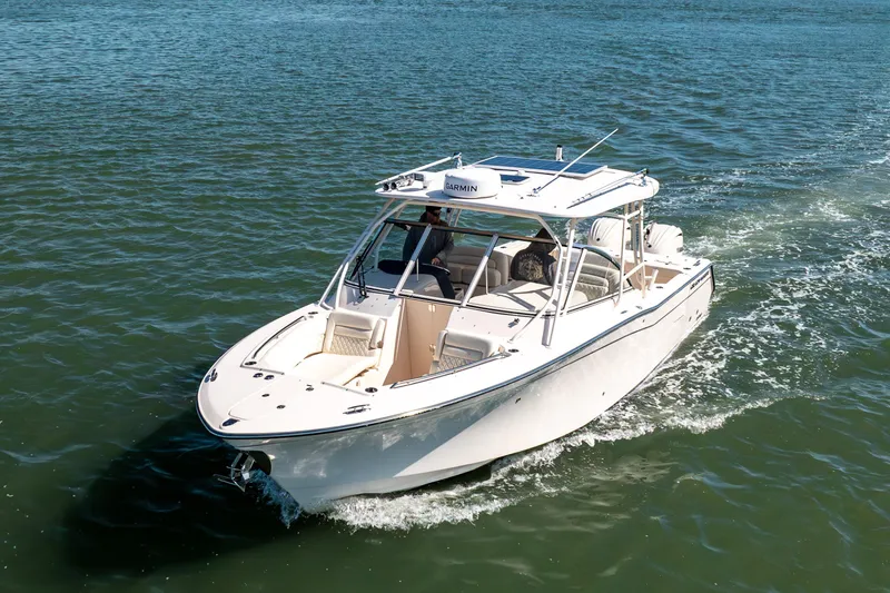 Slide: The Image of 2024 Grady-White Freedom 307 boat cruising on open water. - 1