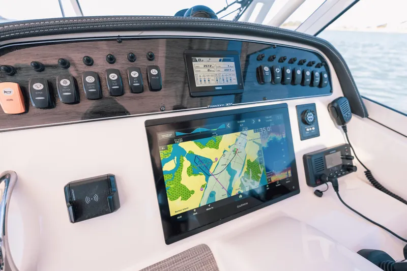 Slide: The Image of 2024 Grady-White Freedom 307 dashboard with navigation and control systems. - 10