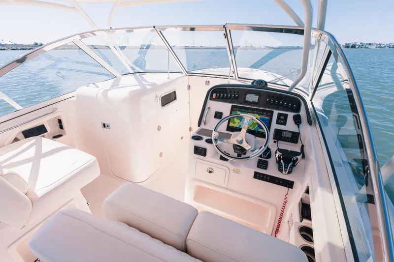 Slide: The Image of 2024 Grady-White Freedom 307 boat cockpit with modern navigation controls and comfortable seating. - 12