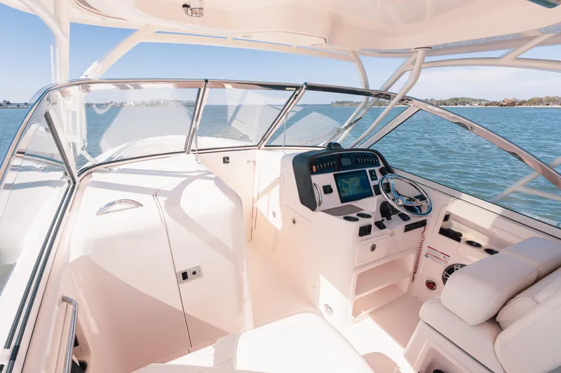 Slide: The Image of 2024 Grady-White Freedom 307 boat interior with steering wheel and control panel. - 13