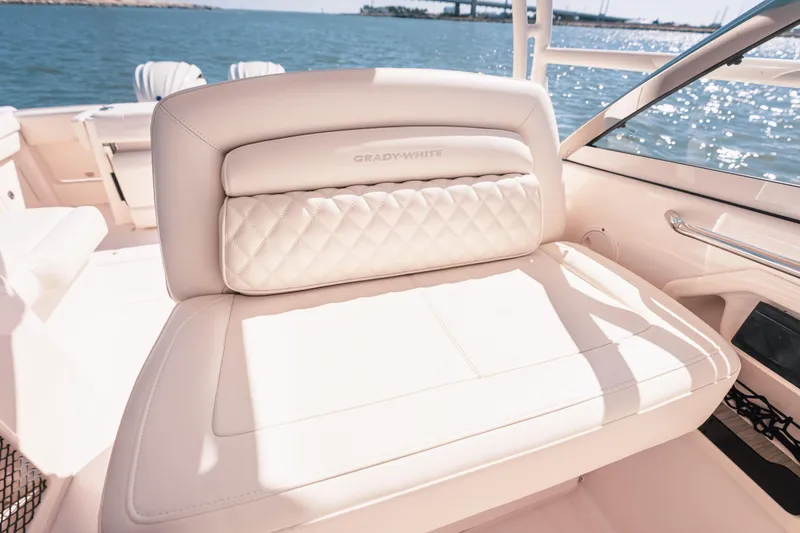 Slide: The Image of 2024 Grady-White Freedom 307 boat interior with luxurious seating by the water. - 16