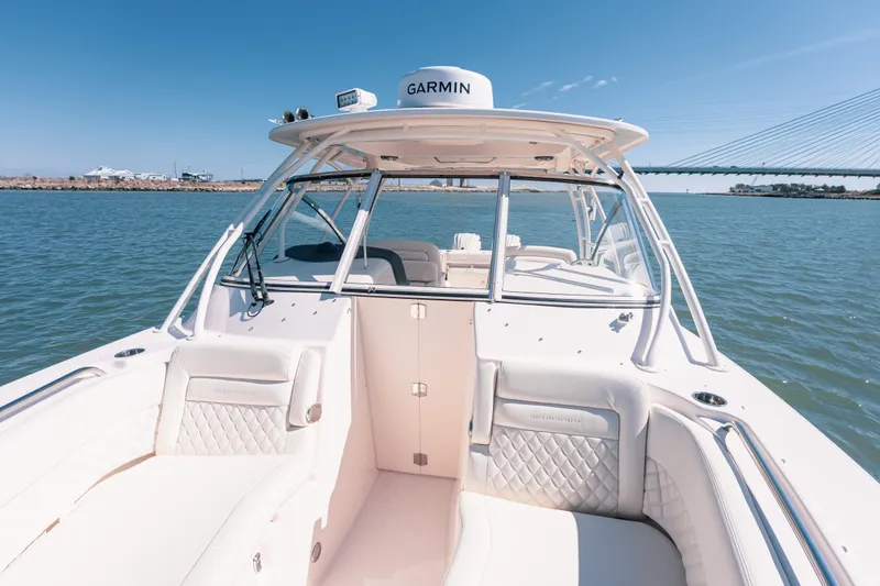 Slide: The Image of 2024 Grady-White Freedom 307 boat on water, featuring spacious seating and Garmin equipment. - 18