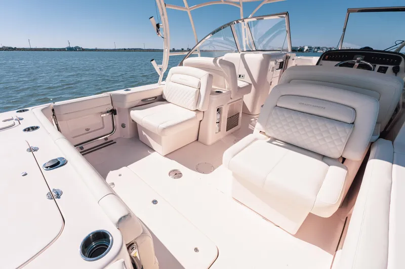 Slide: The Image of 2024 Grady-White Freedom 307 boat interior with luxurious seating on open water. - 19