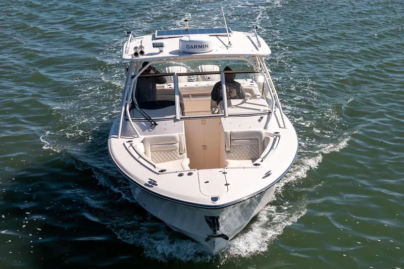 Slide: The Image of 2024 Grady-White Freedom 307 boat cruising on open water. - 2