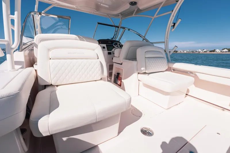 Slide: The Image of 2024 Grady-White Freedom 307 boat interior with luxurious seating on a sunny day. - 20