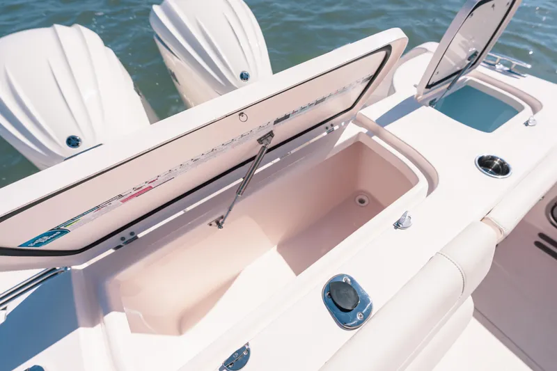 Slide: The Image of 2024 Grady-White Freedom 307 boat with open storage compartments and dual engines. - 21