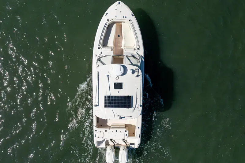 Slide: The Image of Aerial view of 2024 Grady-White Freedom 307 boat cruising on water. - 3