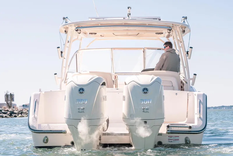 Slide: The Image of 2024 Grady-White Freedom 307 boat with dual Yamaha 300 engines on water. - 8