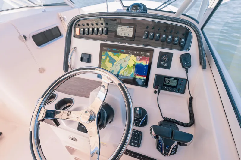 Slide: The Image of 2024 Grady-White Freedom 307 helm with advanced navigation and control systems. - 9