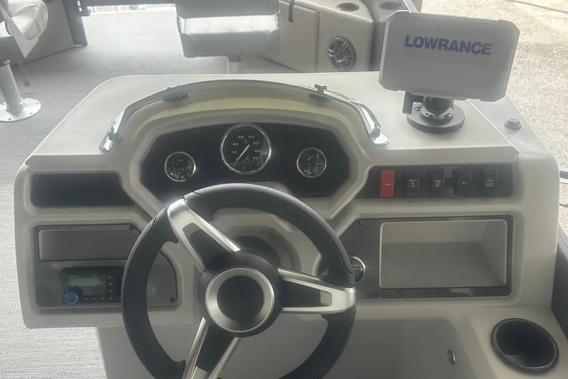 Slide: The Image of Steering console of 2026 Sweetwater 2286FX boat with Lowrance navigation system. - 14