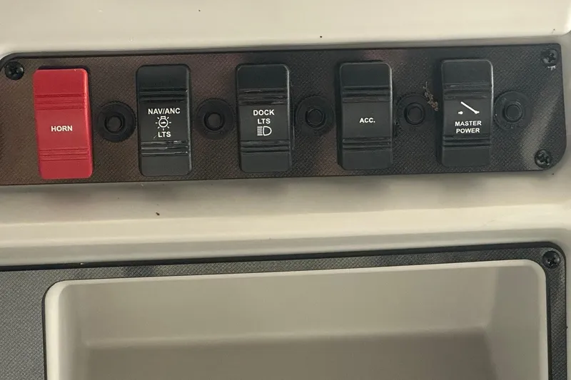 Slide: The Image of Control panel of a 2026 Sweetwater 2286FX boat with labeled switches. - 18