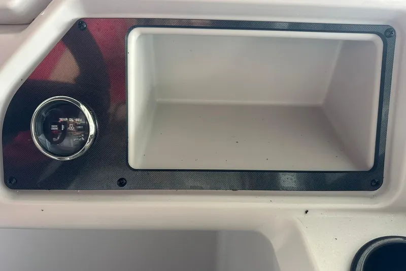 Slide: The Image of Dashboard of 2026 Sweetwater 2286FX boat with gauge and storage compartment. - 19