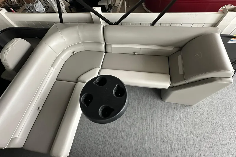 Slide: The Image of Luxurious seating on 2026 Sweetwater 2286FX boat with cup holder table. - 21