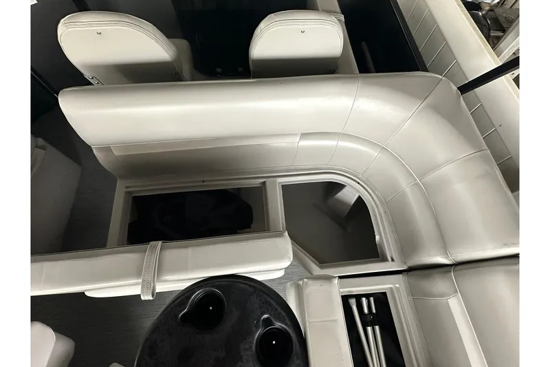 Slide: The Image of Interior of 2026 Sweetwater 2286FX boat with white seating and storage compartments. - 23